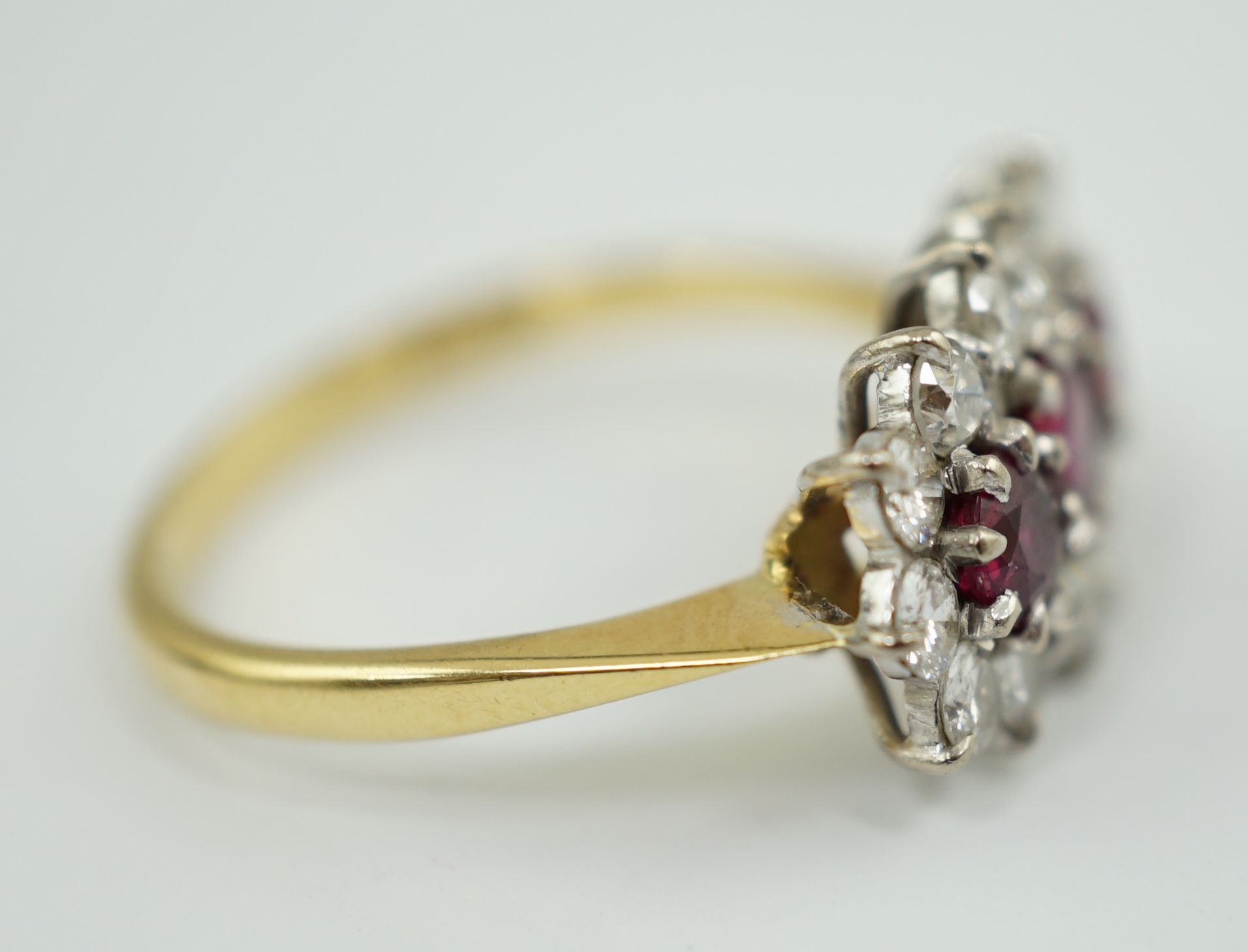 A modern 18ct gold, ruby and diamond set triple cluster ring